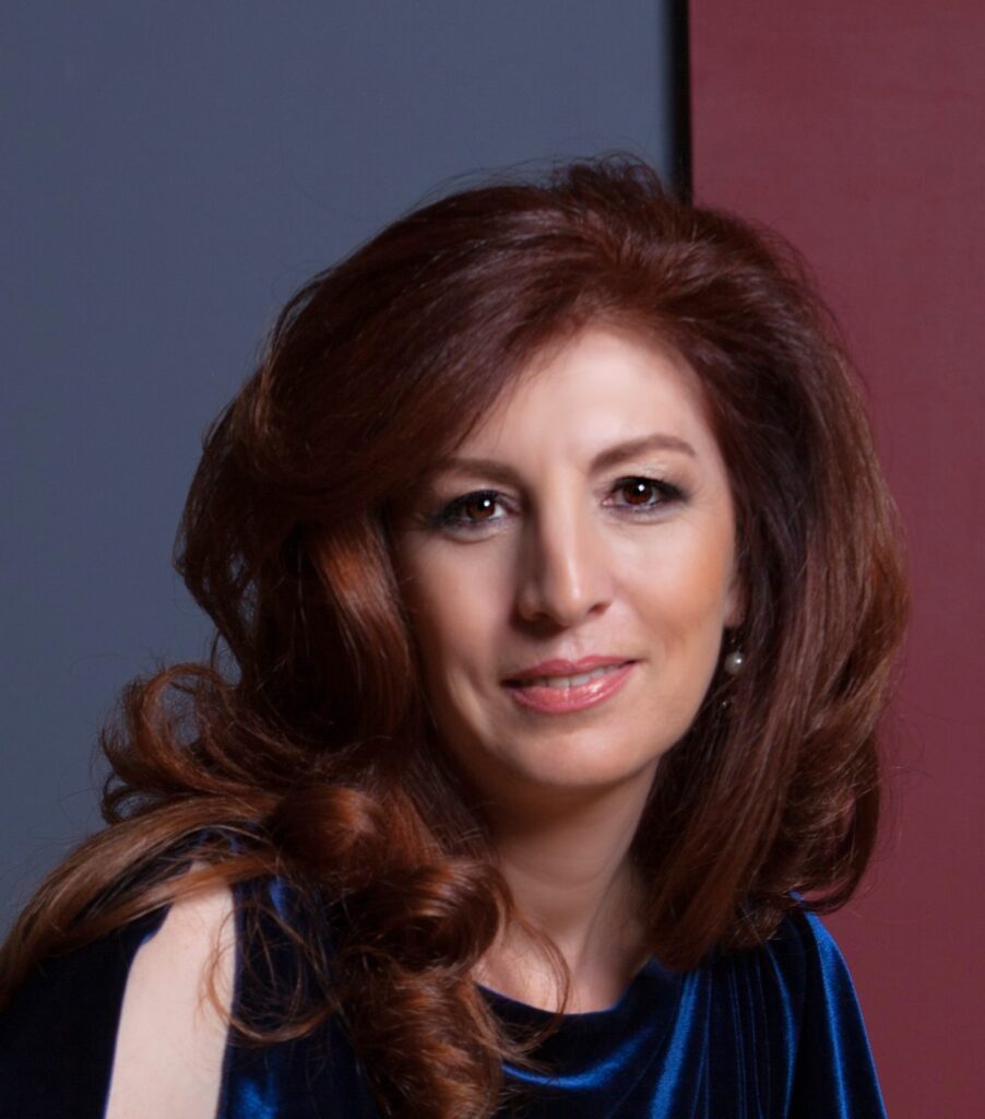 Portrait of a woman with auburn hair and a slight smile.